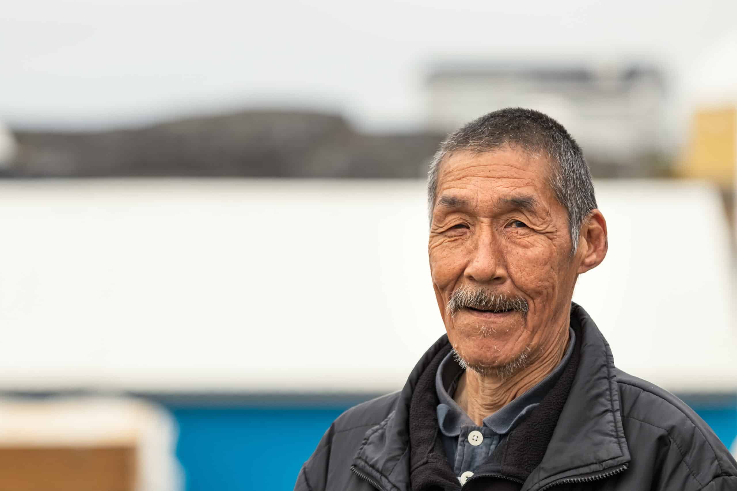 Nuuk, Greenland - August 16, 2019: Portrait of an Inuit local mature man looking camera in Nuuk, Greenland.